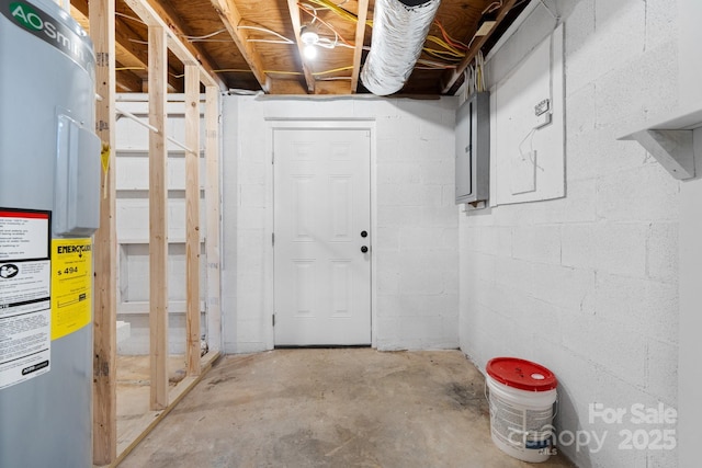 basement featuring electric water heater and electric panel