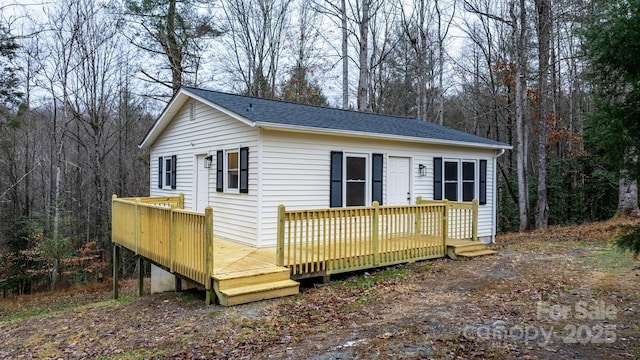 rear view of property with a wooden deck