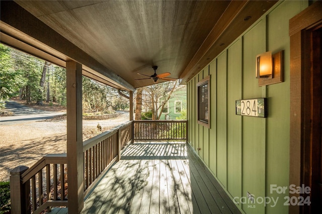 deck with ceiling fan and a porch