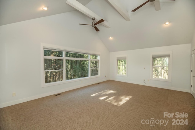 spare room with beam ceiling, carpet floors, high vaulted ceiling, and ceiling fan