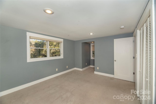 unfurnished bedroom with light colored carpet