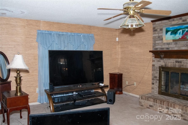 living room with ceiling fan, carpet floors, a textured ceiling, and a fireplace