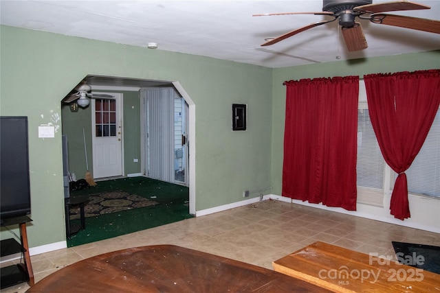 entrance foyer with electric panel and ceiling fan