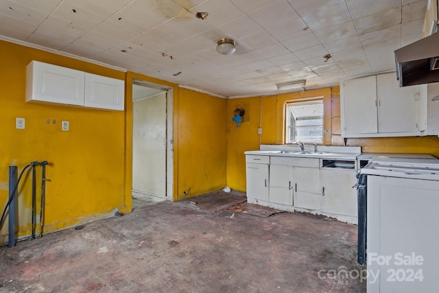 kitchen featuring sink, white cabinets, exhaust hood, and range