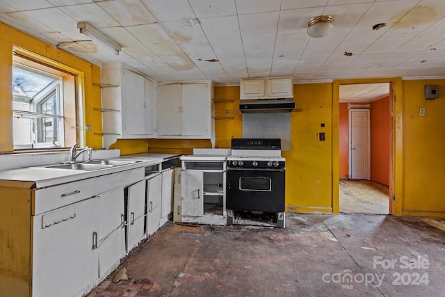 kitchen featuring white cabinets, sink, and gas range gas stove