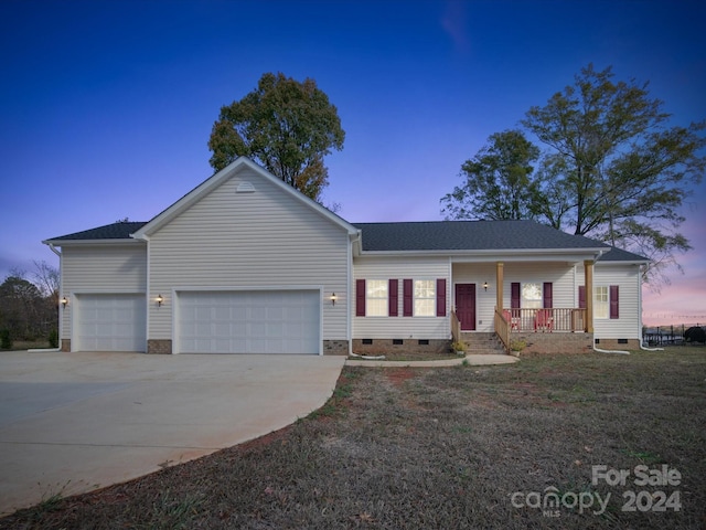 single story home with covered porch and a garage