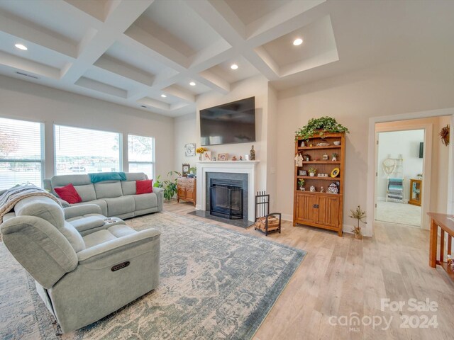 living room with beamed ceiling, light hardwood / wood-style flooring, and coffered ceiling