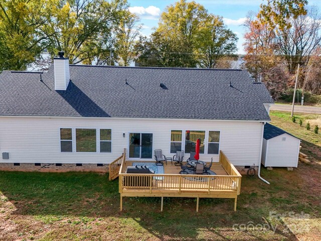 rear view of house with a lawn and a wooden deck