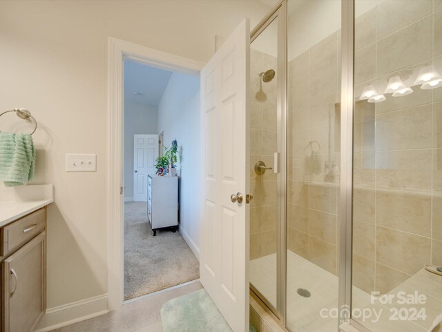 bathroom featuring vanity and a shower with door