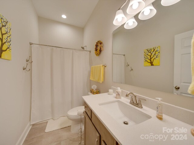 bathroom with tile patterned flooring, vanity, toilet, and walk in shower