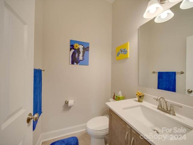 bathroom with tile patterned floors, vanity, and toilet