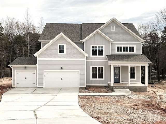 view of front facade with concrete driveway, roof with shingles, crawl space, a porch, and board and batten siding