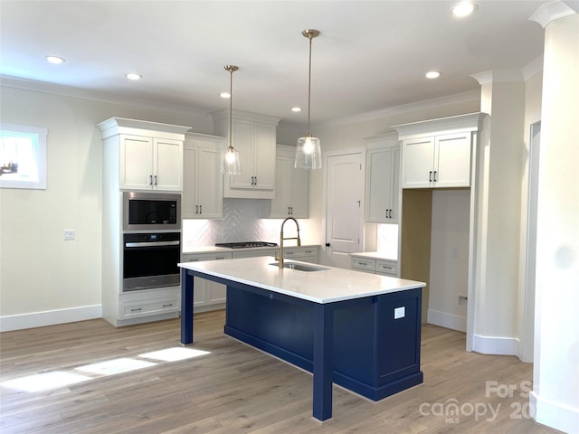 kitchen featuring oven, a sink, built in microwave, light wood-style floors, and backsplash