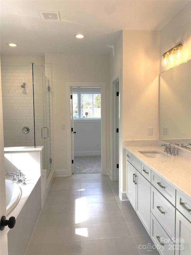 full bath featuring tile patterned flooring, vanity, visible vents, a bath, and a stall shower