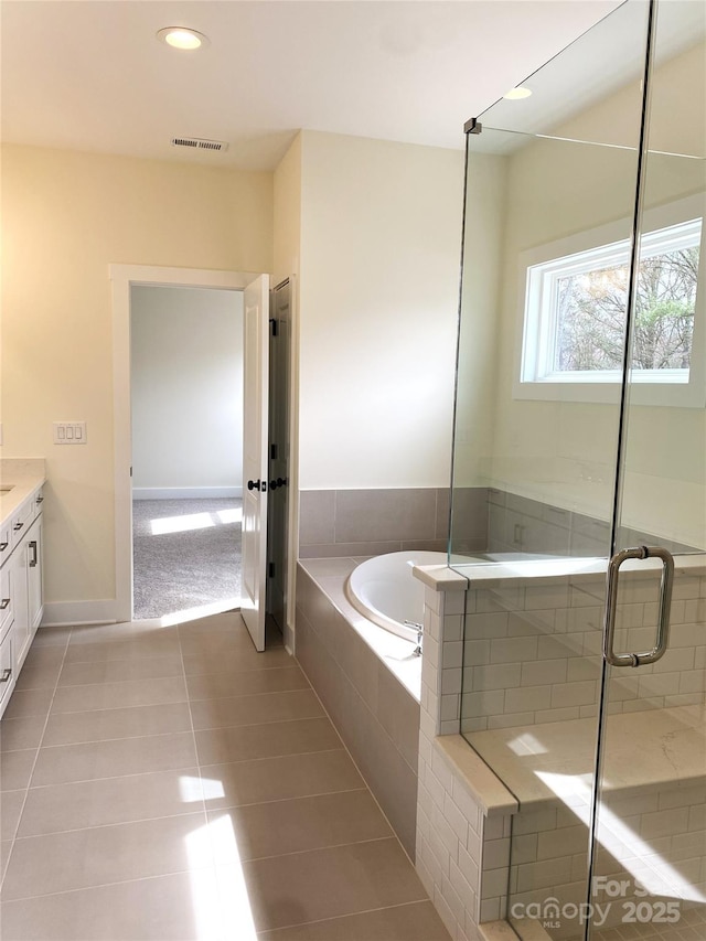 full bath featuring a garden tub, tile patterned flooring, vanity, visible vents, and a stall shower