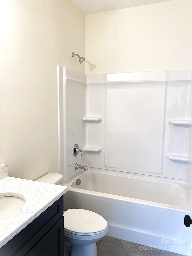 bathroom with toilet, bathing tub / shower combination, vanity, and tile patterned floors