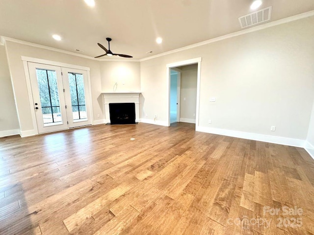 unfurnished living room featuring ceiling fan, crown molding, and light hardwood / wood-style flooring