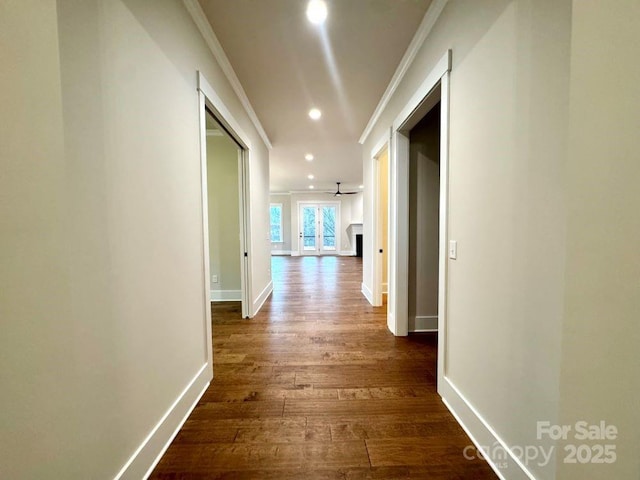 hall featuring dark hardwood / wood-style floors and crown molding