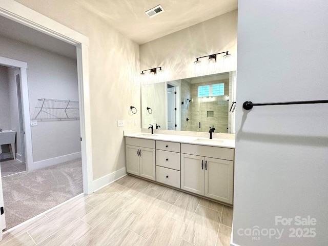 bathroom featuring vanity and a shower with shower door