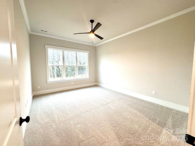 spare room with carpet, ceiling fan, and ornamental molding