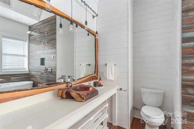 bathroom featuring hardwood / wood-style flooring, vanity, and toilet