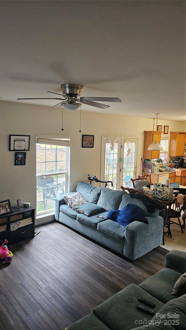 living room with ceiling fan and plenty of natural light