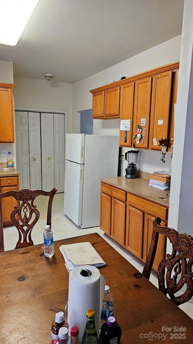 kitchen featuring white fridge and light hardwood / wood-style flooring