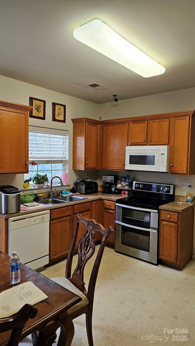 kitchen with sink and white appliances