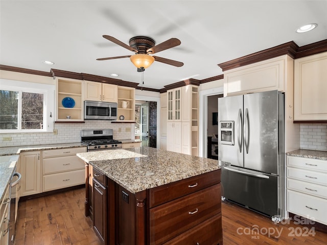 kitchen with dark brown cabinets, dark hardwood / wood-style flooring, light stone countertops, and stainless steel appliances