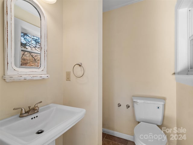 bathroom featuring tile patterned floors, toilet, and sink