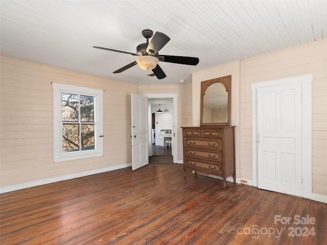 unfurnished bedroom with ceiling fan and dark hardwood / wood-style floors