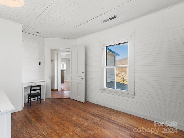 unfurnished room featuring dark hardwood / wood-style flooring and wooden ceiling