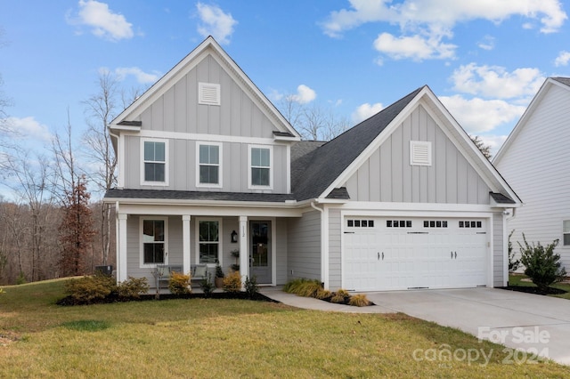 view of front facade featuring a front yard, a porch, and a garage