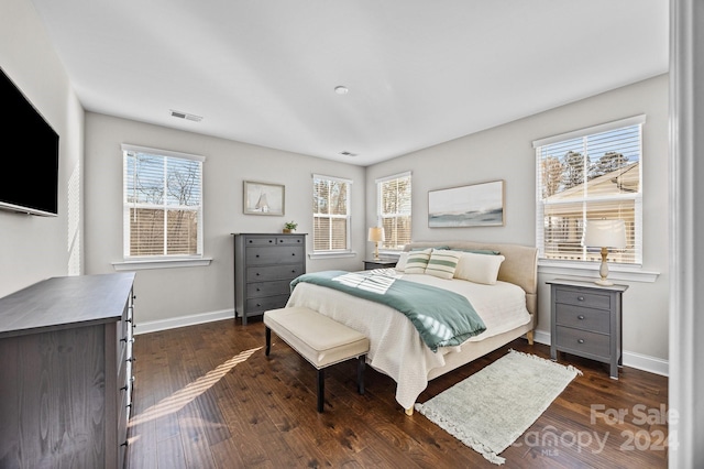 bedroom with dark wood-type flooring