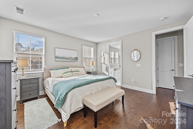 bedroom with connected bathroom and dark hardwood / wood-style floors