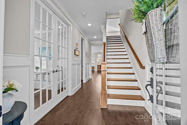 entrance foyer featuring french doors, dark hardwood / wood-style floors, and ornamental molding