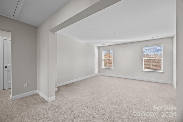 carpeted spare room with a healthy amount of sunlight