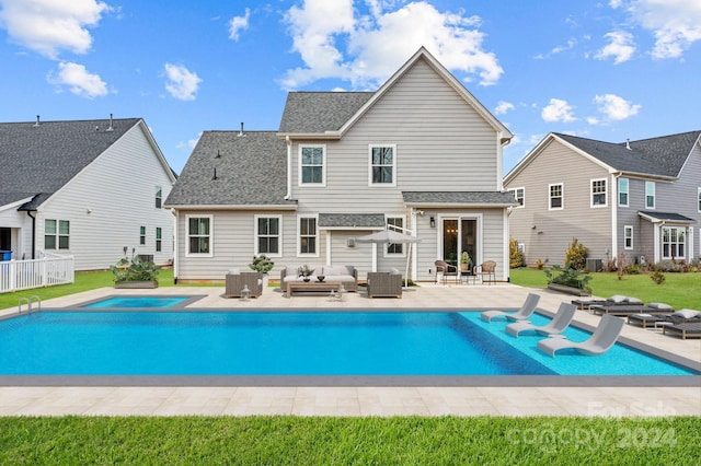 back of house with an outdoor living space, a patio, and central AC