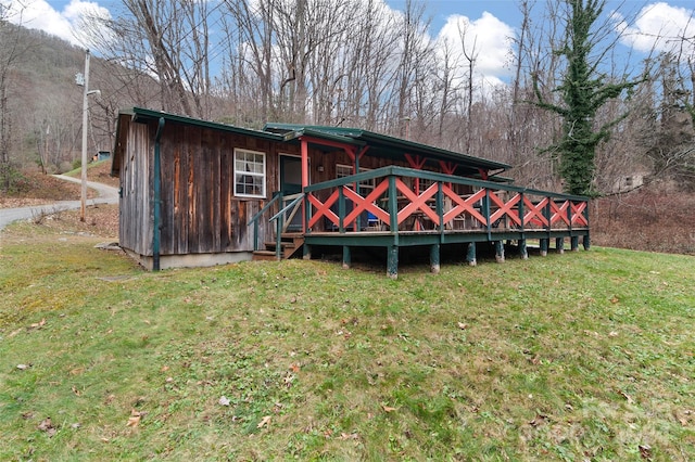 rear view of house featuring a yard