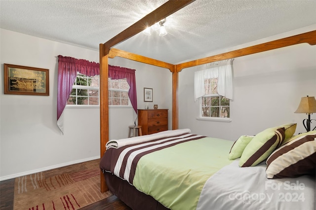 bedroom featuring hardwood / wood-style flooring and a textured ceiling