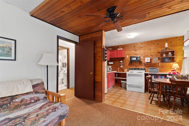 carpeted living room with wood walls, ceiling fan, and wood ceiling