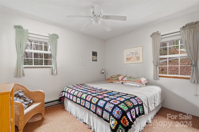 bedroom featuring ceiling fan, carpet, a textured ceiling, and a baseboard heating unit