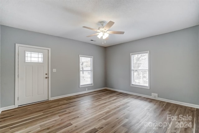 foyer entrance with light wood-type flooring and ceiling fan