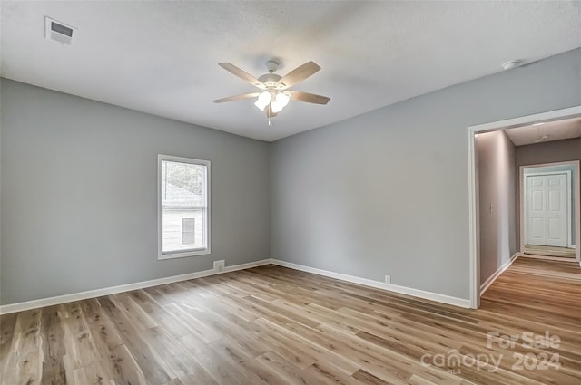 spare room with light hardwood / wood-style flooring and ceiling fan