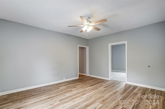 unfurnished room featuring light wood-type flooring and ceiling fan