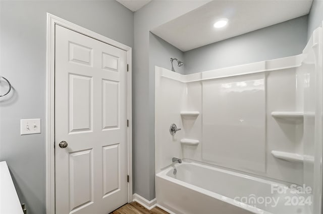 bathroom featuring tub / shower combination and hardwood / wood-style flooring