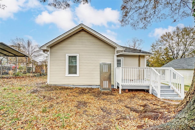 rear view of property featuring a deck