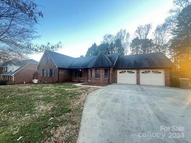 view of front of house featuring a garage and a front lawn