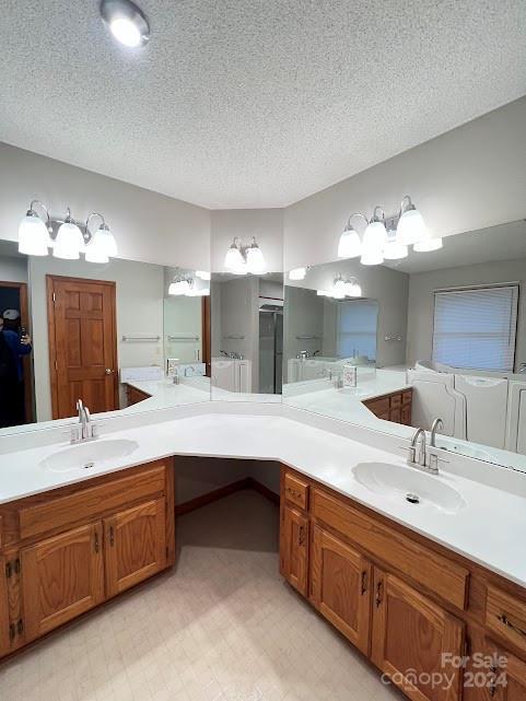 bathroom featuring vanity and a textured ceiling