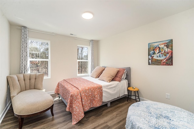 bedroom with dark hardwood / wood-style flooring